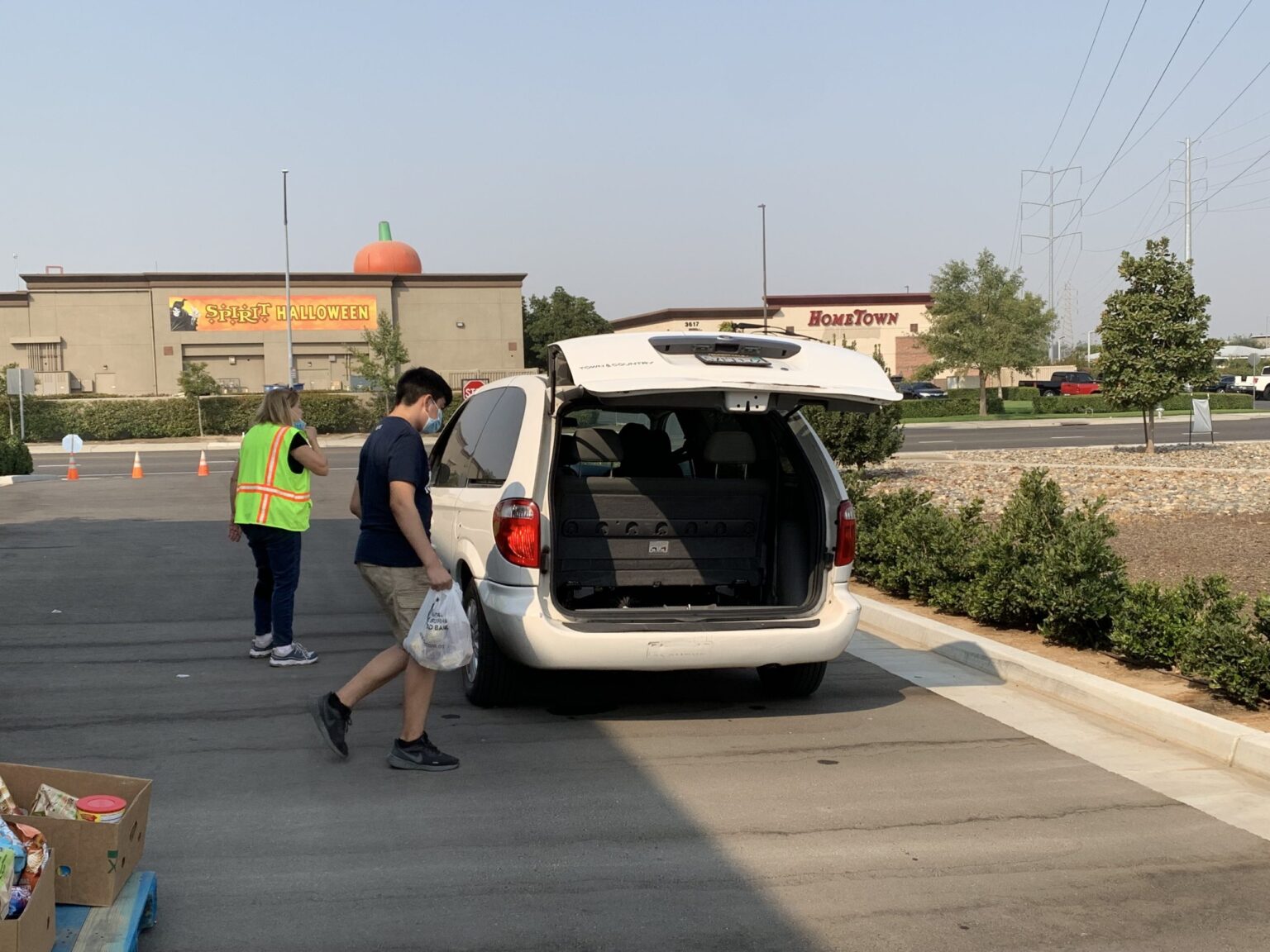 ACTS volunteers loading groceries for a neighbor